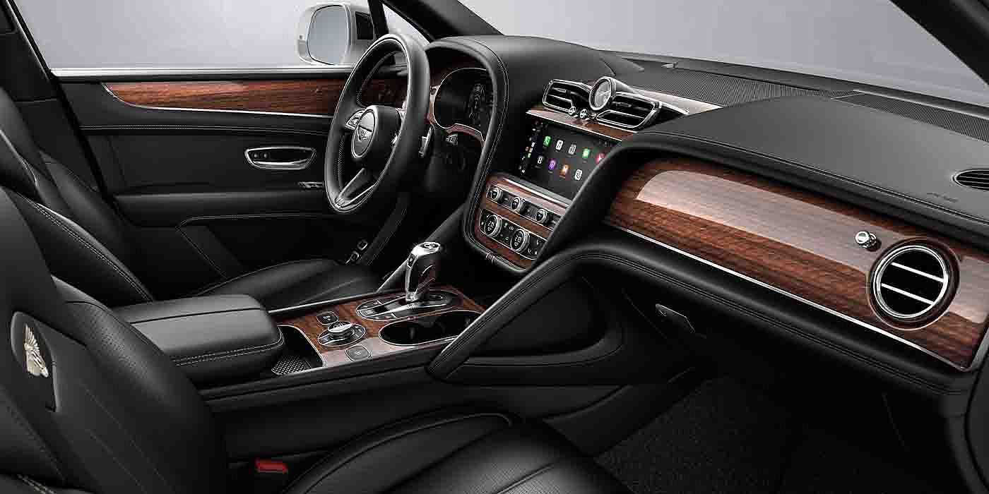 Bentley Singapore Bentley Bentayga EWB interior with a Crown Cut Walnut veneer, view from the passenger seat over looking the driver's seat.