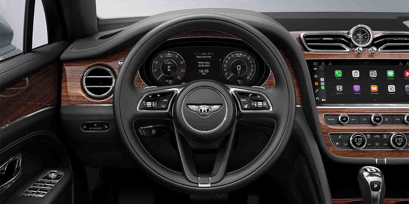 Bentley Singapore Bentley Bentayga EWB driver's view - featuring steering wheel in Belgua hide and dashboard with Crown Cut Walnut veneer.