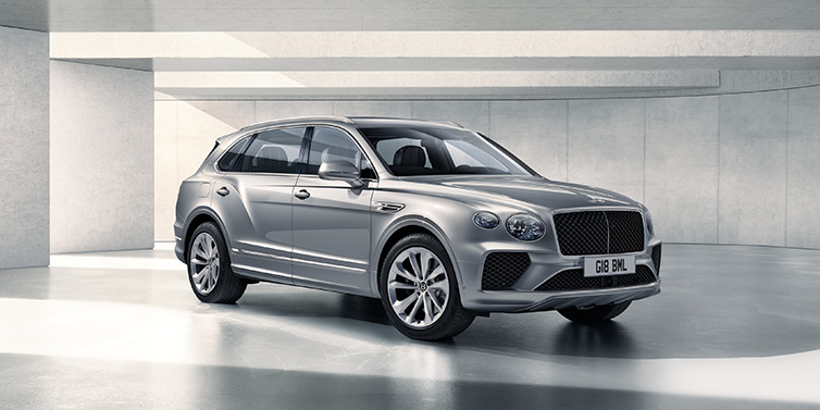 Bentley Singapore Bentley Bentayga Extended Wheelbase SUV front three quarter in Moonbeam paint with a grey background