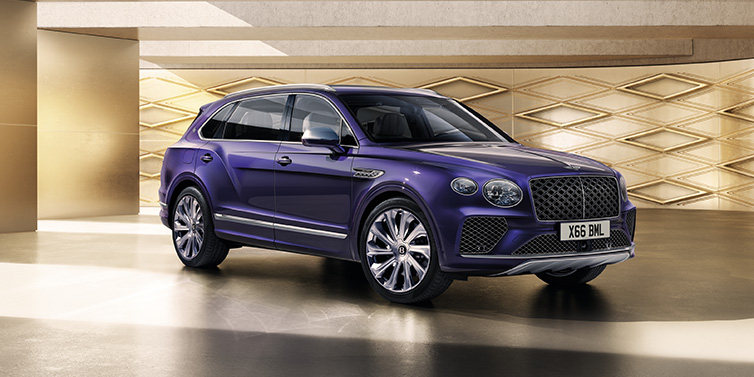 Bentley Singapore Bentley Bentayga Extended Wheelbase Mulliner SUV front three quarter in Tanzanite Purple paint with a gold patterned background