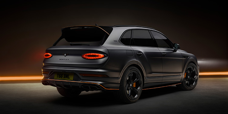 Bentley Singapore Bentley Bentayga S Black Edition SUV rear three quarter in Anthracite Satin paint against a dark red and yellow background