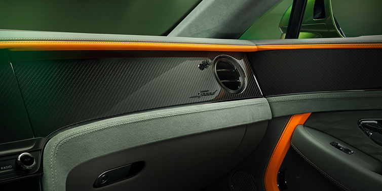 Bentley Singapore Bentley Continental GT Speed coupe front interior dash detail with high gloss carbon fibre veneer surrounded by Mandarin by Mulliner and Gravity Grey hides