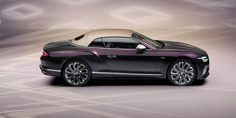 Bentley Singapore Bentley Continental GTC Mulliner convertible in profile with hood up, in Tanzanite Purple paint and 22 inch Mulliner painted and polished wheels