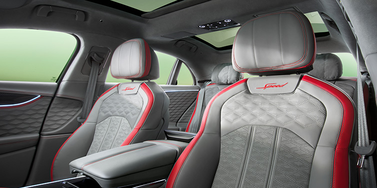 Bentley Singapore Bentley Flying Spur Speed sedan interior showing front and rear seats in Hotspur red and Gravity Grey hides, with Speed seat emblems