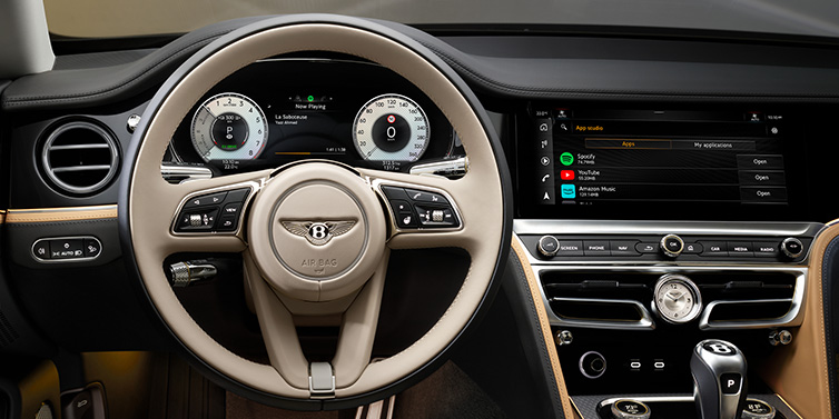 Bentley Singapore Bentley Flying Spur Mulliner sedan front interior detail of steering wheel and driver screens surrounded by Linen and Beluga black hides