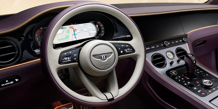 Bentley Singapore Bentley Continental GT Mulliner coupe front interior showing steering wheel and drivers screens surrounded by Linen and Damson hides and Grand Black veneer